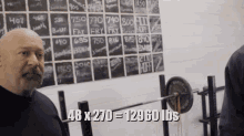 a man is lifting a barbell in front of a chalkboard that says 48 x 270 = 12960 lbs on it