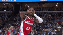 a basketball player wearing a red jersey with the number 12 on it
