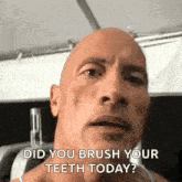 a bald man is asking if he should brush his teeth .